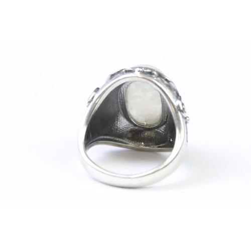 225 - A 925 Sterling silver with moonstone cabochon to centre ladies ring with decorative floral shoulders... 