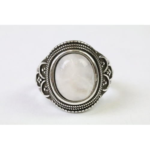 230 - A 925 Sterling Silver with Moonstone cabochon ladies ring with decorative design to shoulders, marke... 