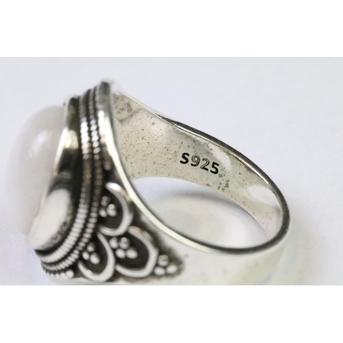 230 - A 925 Sterling Silver with Moonstone cabochon ladies ring with decorative design to shoulders, marke... 