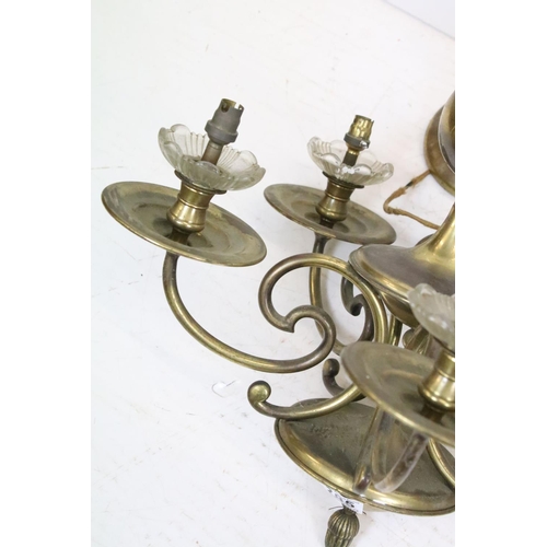 385 - A pair of brass five branch ceiling lights together with two pairs of two branch wall lights.