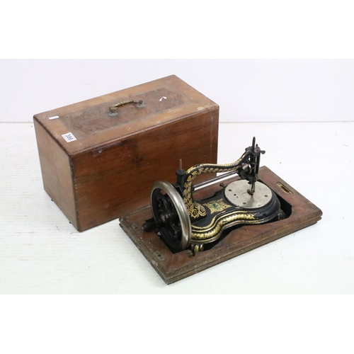 386 - An early 20th century cast iron sewing machine within fitted wooden box together with a vintage type... 