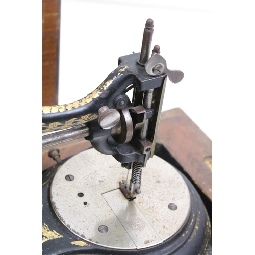 386 - An early 20th century cast iron sewing machine within fitted wooden box together with a vintage type... 