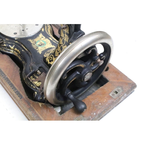 386 - An early 20th century cast iron sewing machine within fitted wooden box together with a vintage type... 