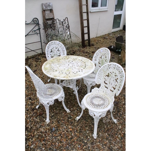 531 - White painted cast metal patio table with four matching chairs, table approx 65cm high