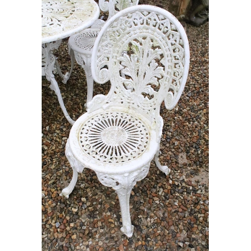 531 - White painted cast metal patio table with four matching chairs, table approx 65cm high