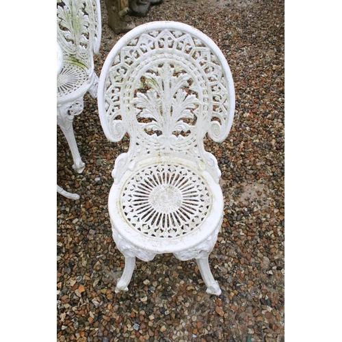 531 - White painted cast metal patio table with four matching chairs, table approx 65cm high