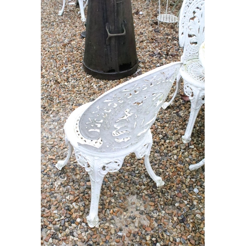 531 - White painted cast metal patio table with four matching chairs, table approx 65cm high