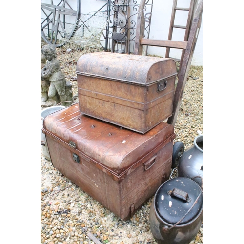 534 - Two metal trunks, together with two churns, a cast iron pot and a Slingsby wooden sack truck