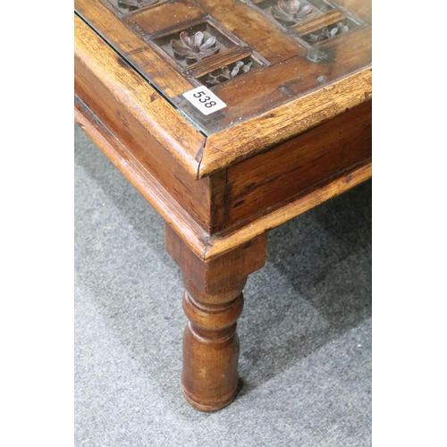 538 - Indian Hardwood Coffee Table, the top formed from an antique decorative door with carved flowers set... 