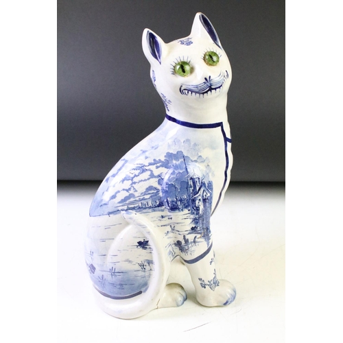 12 - Galle style Delft ware blue & white pottery model of a seated cat, with glass eyes (approx 35cm high... 