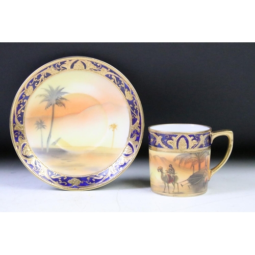 21 - Japanese Noritake coffee set with hand painted desert scenes depicting a figure riding a camel besid... 