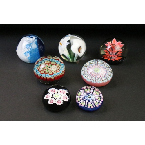 39 - Seven glass paperweights to include Caithness & Langham examples, featuring Caithness Peach Floral F... 