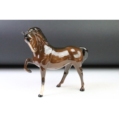 41 - Five Beswick porcelain horses / foals to include four brown gloss examples (prancing stallion, mare ... 