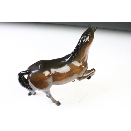 41 - Five Beswick porcelain horses / foals to include four brown gloss examples (prancing stallion, mare ... 