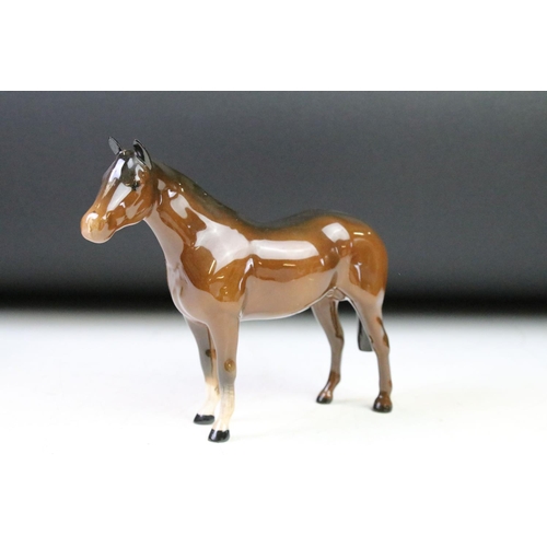 41 - Five Beswick porcelain horses / foals to include four brown gloss examples (prancing stallion, mare ... 