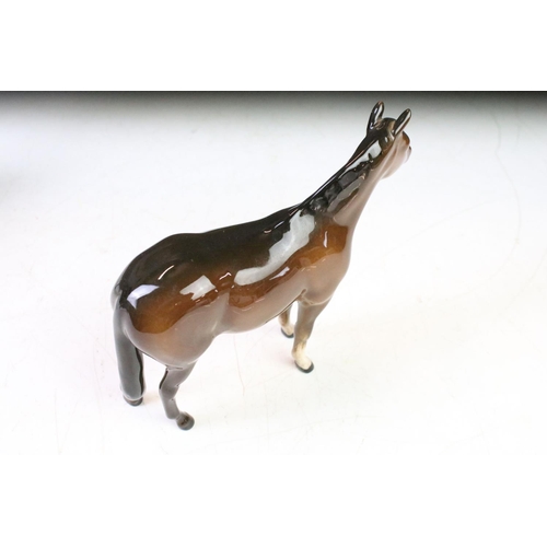 41 - Five Beswick porcelain horses / foals to include four brown gloss examples (prancing stallion, mare ... 