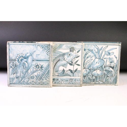 44 - Three ceramic tiles with hand painted designs depicting mushrooms, a stylised fish, and a bird perch... 