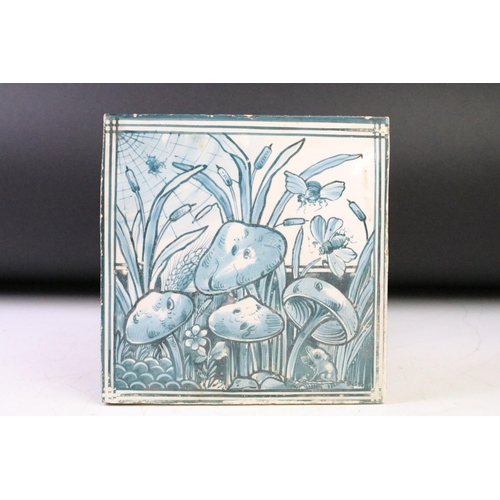 44 - Three ceramic tiles with hand painted designs depicting mushrooms, a stylised fish, and a bird perch... 