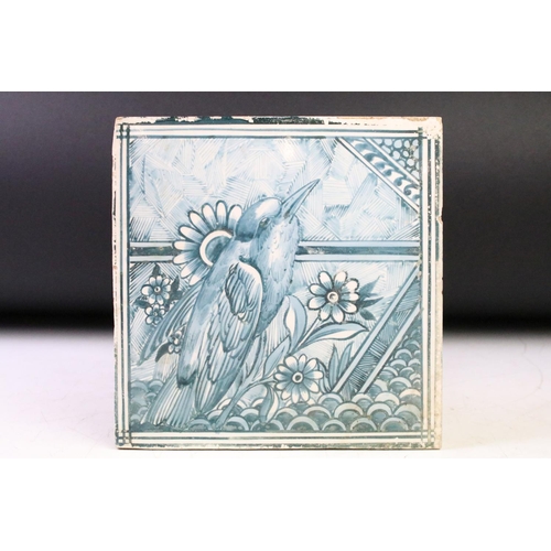 44 - Three ceramic tiles with hand painted designs depicting mushrooms, a stylised fish, and a bird perch... 