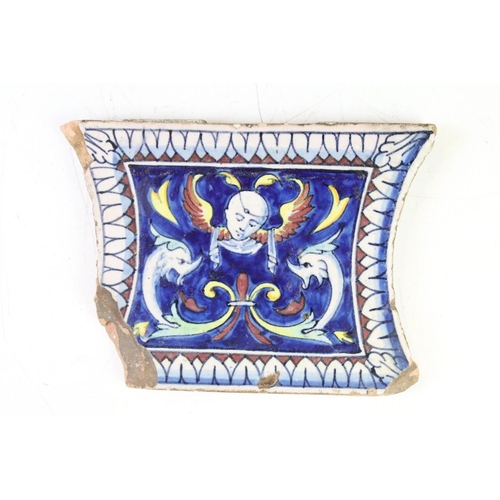 57 - Three Continental ceramic tiles with glazed mythical style decoration on blue ground, with repeating... 