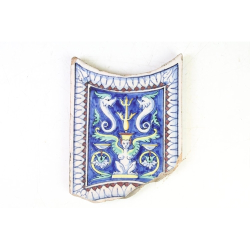 57 - Three Continental ceramic tiles with glazed mythical style decoration on blue ground, with repeating... 