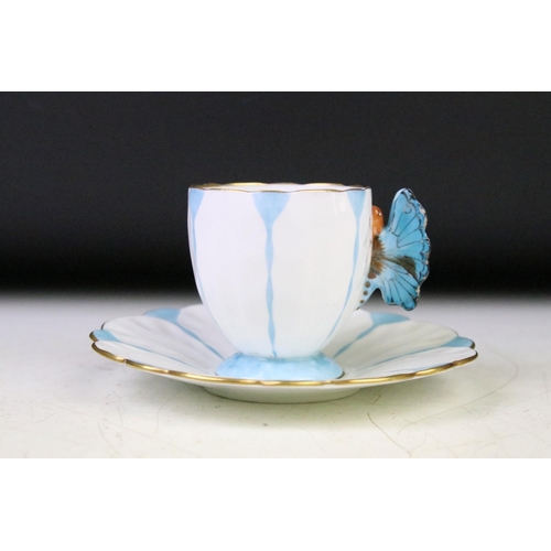 74 - Aynsley Art Deco tea cup and saucer having a butterfly formed handle, gilt rims and blue hand painte... 