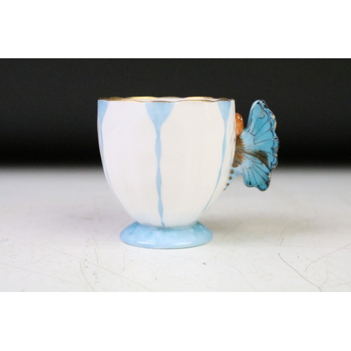 74 - Aynsley Art Deco tea cup and saucer having a butterfly formed handle, gilt rims and blue hand painte... 