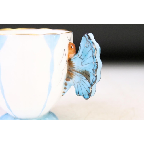 74 - Aynsley Art Deco tea cup and saucer having a butterfly formed handle, gilt rims and blue hand painte... 