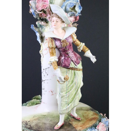 84 - 20th Century large ceramic centre piece vase having an applied figure of a woman with floral encrust... 