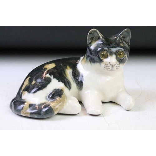 110 - Five Winstanley ceramic studio pottery cats each with yellow glass eyes, together with an Italian ce... 