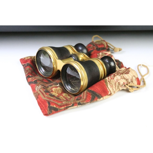 28 - A pair of mid 20th century leather clad binoculars with decorative gilt decoration housed within a s... 