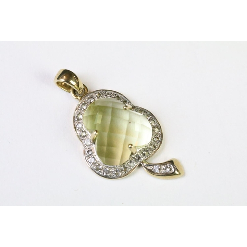 58 - A hallmarked 9ct gold pendant in the form of a three leaf clover, faceted Citrine center stone surro... 