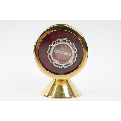 255 - A religious relic of S. Patricil E.C. housed within a circular brass display case.