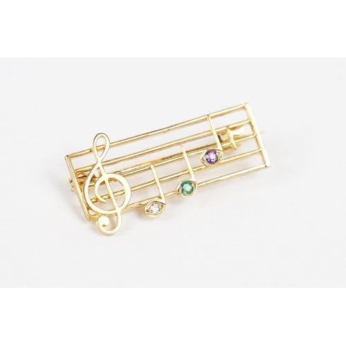 259 - A ladies hallmarked 9ct gold brooch in the form of musical notes.