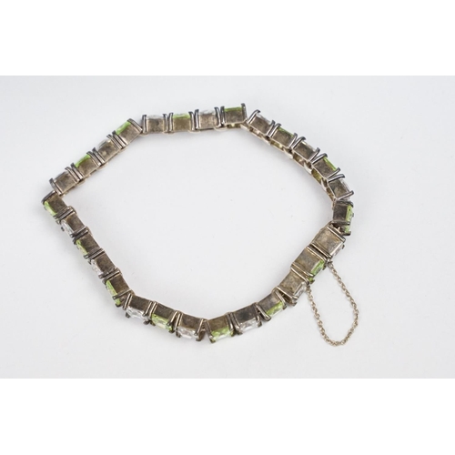 268 - A contemporary 925 sterling silver tennis bracelet set with light green and clear stones, complete w... 