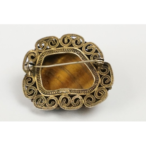 272 - A vintage 925 sterling silver ladies brooch set with large central tigers eye and surround by filigr... 