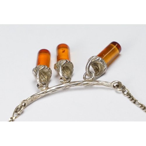 278 - A contemporary 925 sterling silver necklace with three amber style hanging drops on Figaro chain, ma... 