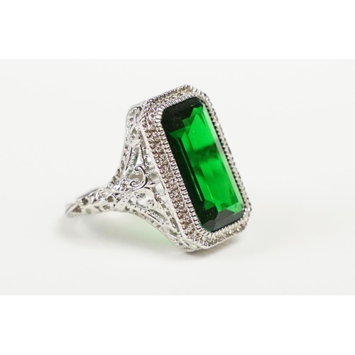 279 - A 925 sterling silver ladies dress ring of classical style with green centre stone raised to pieced ... 