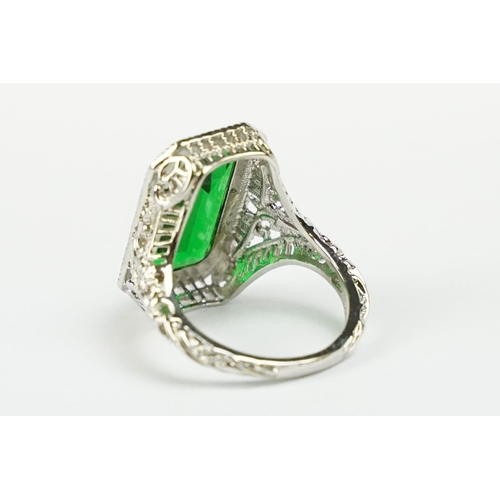 279 - A 925 sterling silver ladies dress ring of classical style with green centre stone raised to pieced ... 