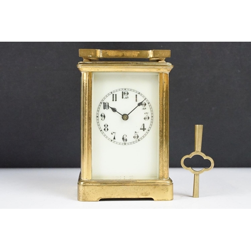 288 - An antique 19th century brass cased carriage clock with beveled glass panels, complete with key.