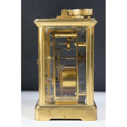 288 - An antique 19th century brass cased carriage clock with beveled glass panels, complete with key.