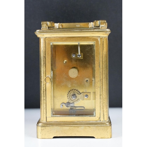 288 - An antique 19th century brass cased carriage clock with beveled glass panels, complete with key.