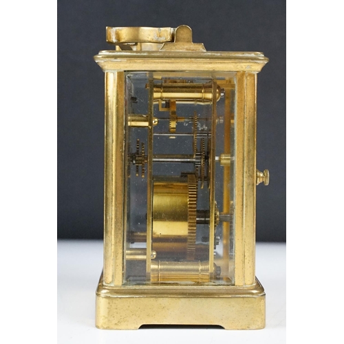 288 - An antique 19th century brass cased carriage clock with beveled glass panels, complete with key.