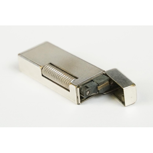 290 - A mid 20th century silver plated Dunhill pocket lighter with service reciept.