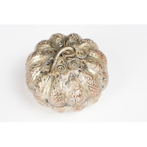 296 - A vintage white metal betal nut holder in the form of a pumpkin with ornate pierced decoration toget... 