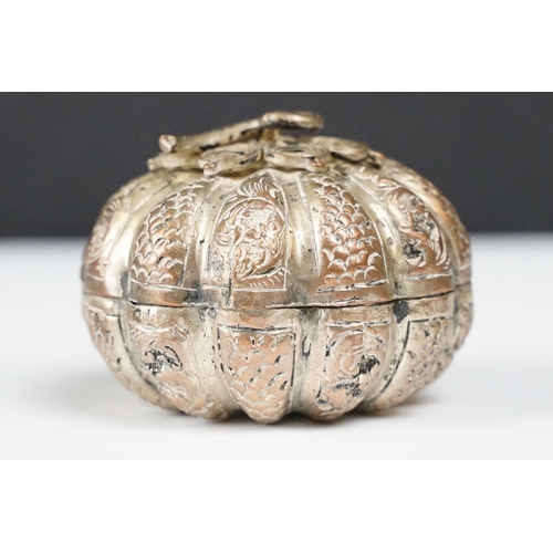 296 - A vintage white metal betal nut holder in the form of a pumpkin with ornate pierced decoration toget... 