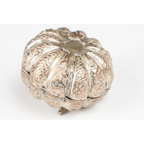 296 - A vintage white metal betal nut holder in the form of a pumpkin with ornate pierced decoration toget... 