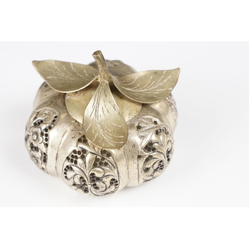 296 - A vintage white metal betal nut holder in the form of a pumpkin with ornate pierced decoration toget... 