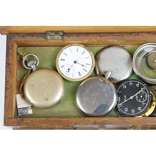 318 - A wooden watchmakers box together with contents to include wristwatches, pocket watches and parts.