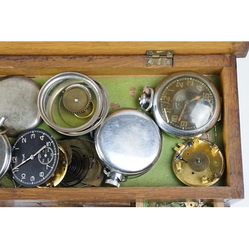 318 - A wooden watchmakers box together with contents to include wristwatches, pocket watches and parts.